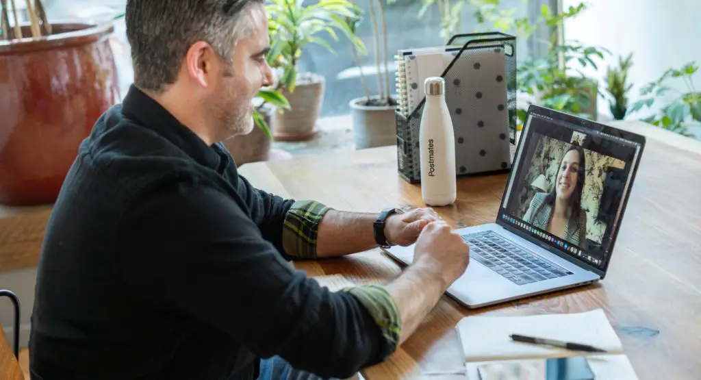 A salesperson working in an office on a virtual call